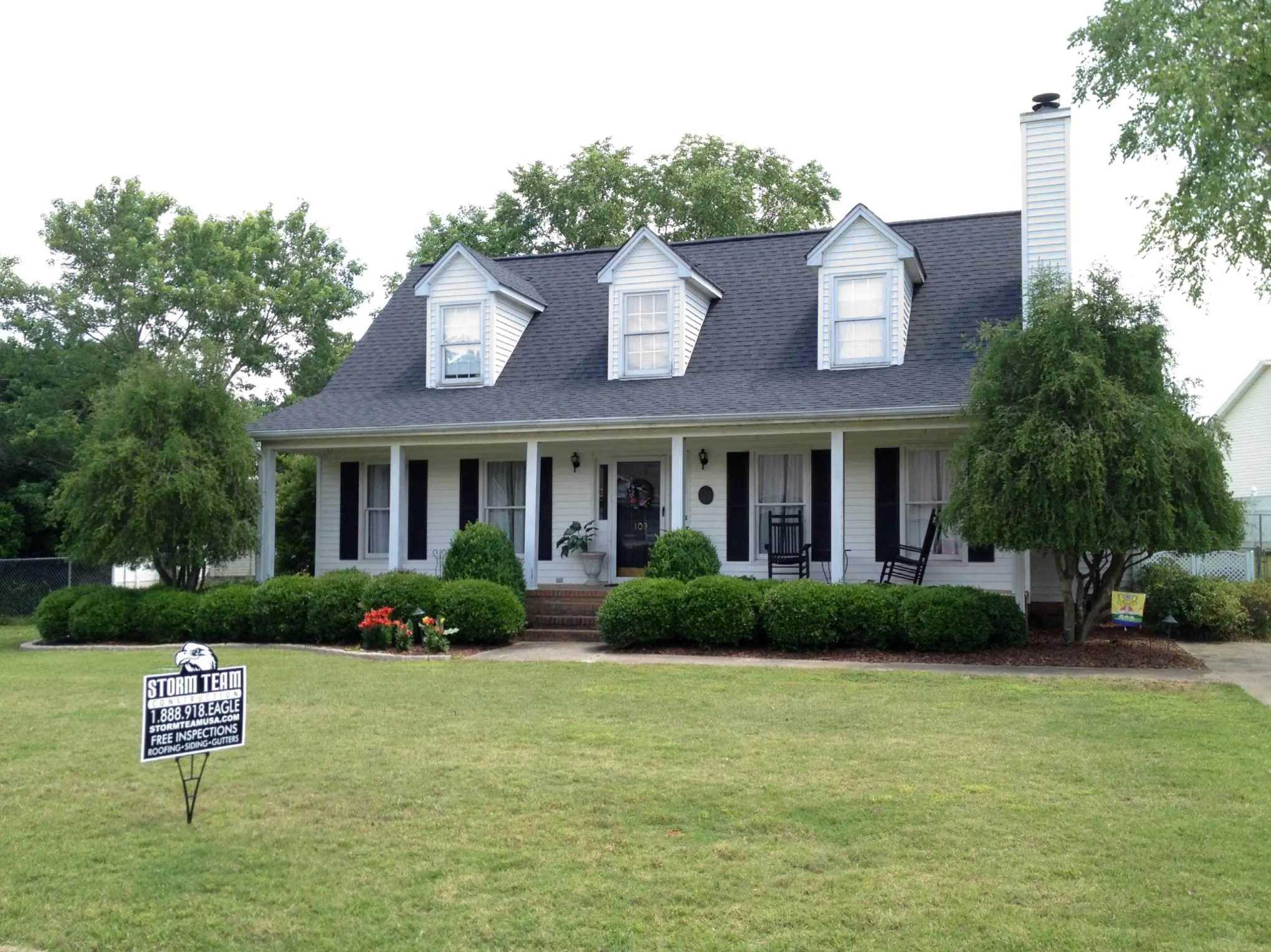 After photo showing finished roof and gutters, wide scale placement near closing